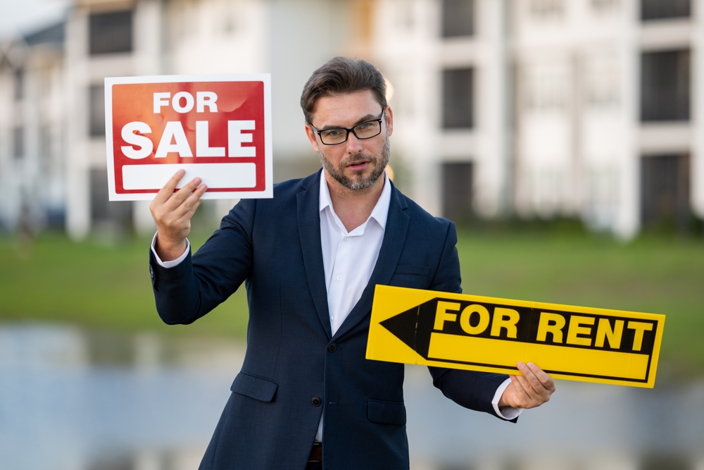 American,House,Seller,,Real,Estate,Agents,Hold,Sign,For,Sale